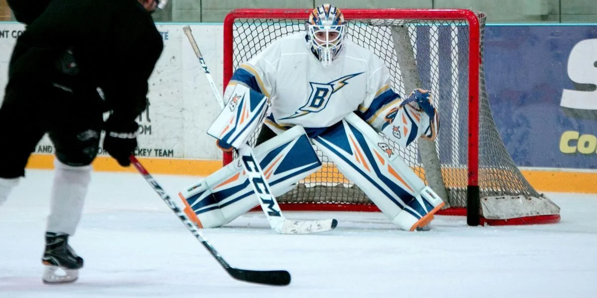 A hockey goalie guarding the net.