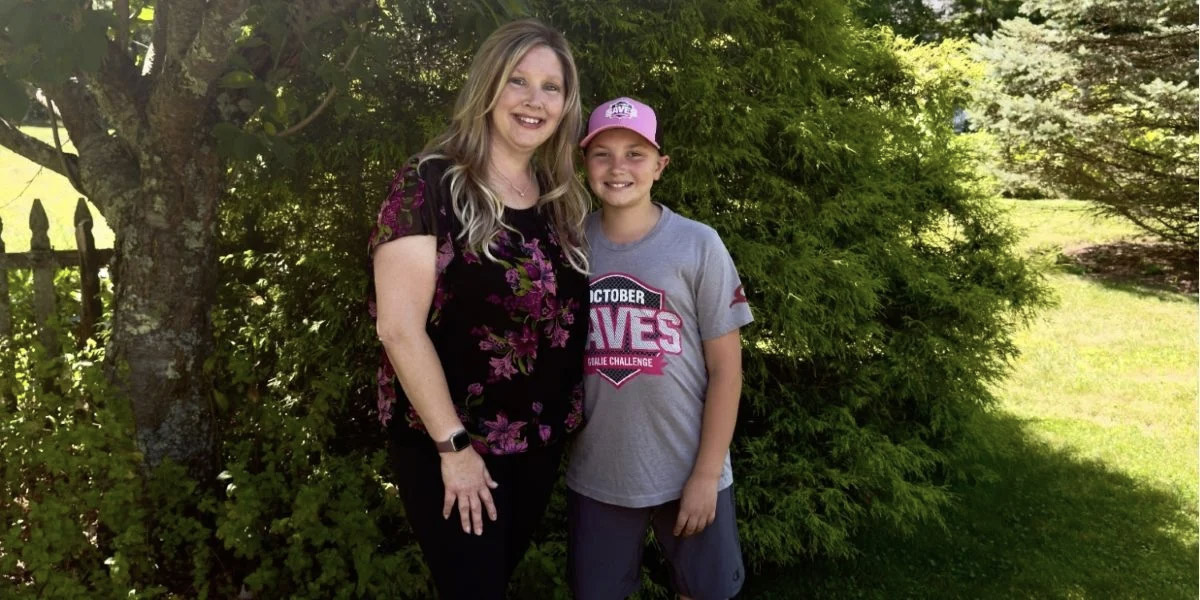 Young Massachusetts goalie standing with his mom, supporting October Saves.